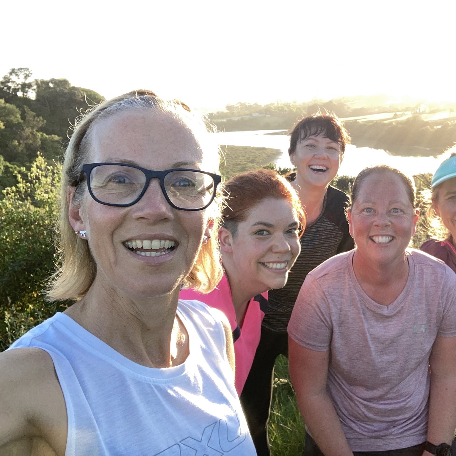 A beaming group of 261 Fearless women take a selfie during a run in nature