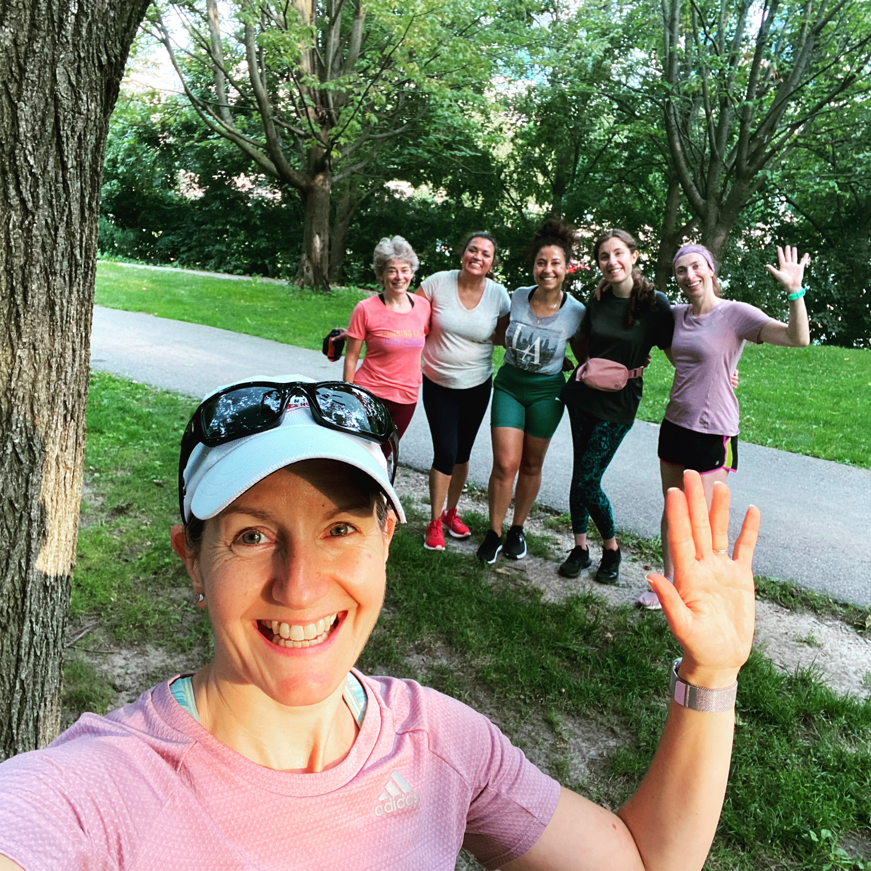 Selfie of a group happy female 261 Fearless runners , enjoying a sunny day in a lush park, reflecting the spirit of camaraderie and joy in fitness